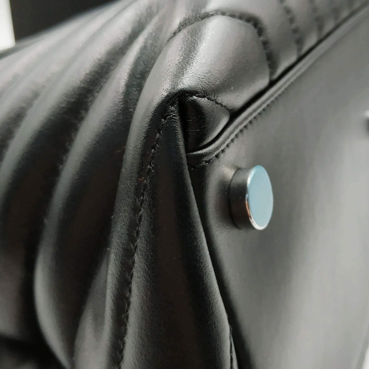 Close-up of Loulou bags hardware and fine stitching