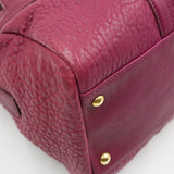 Close-up of Pebbled bags hardware and fine stitching