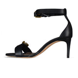 Close-up of Alexander McQueen sandals hardware and fine stitching