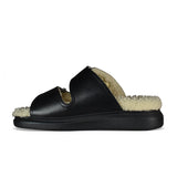 Close-up of Alexander McQueen sandals hardware and fine stitching