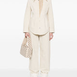 Close-up of Bottega Veneta pants hardware and fine stitching